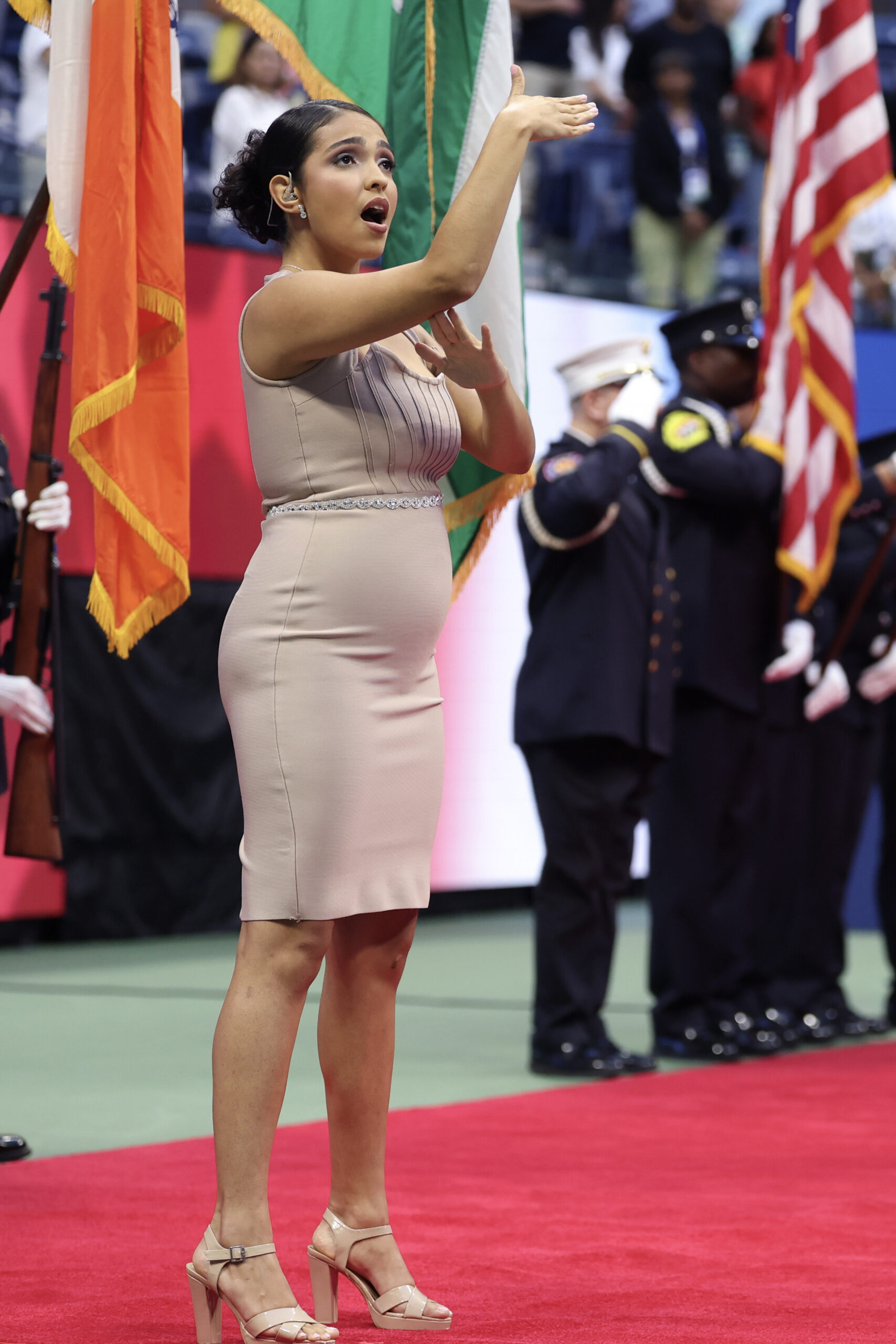 Sign language interpreter, Anjel Piñero, performs the National Anthem during the opening ceremony prior to a women's singles match at the 2024 US Open on Monday, Aug. 26, 2024 in Flushing, NY. (Simon Bruty/USTA)